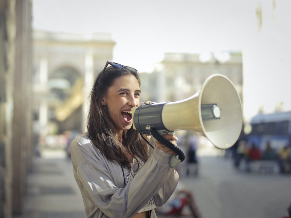 A lady shouting through a megaphone that she's just written great content 