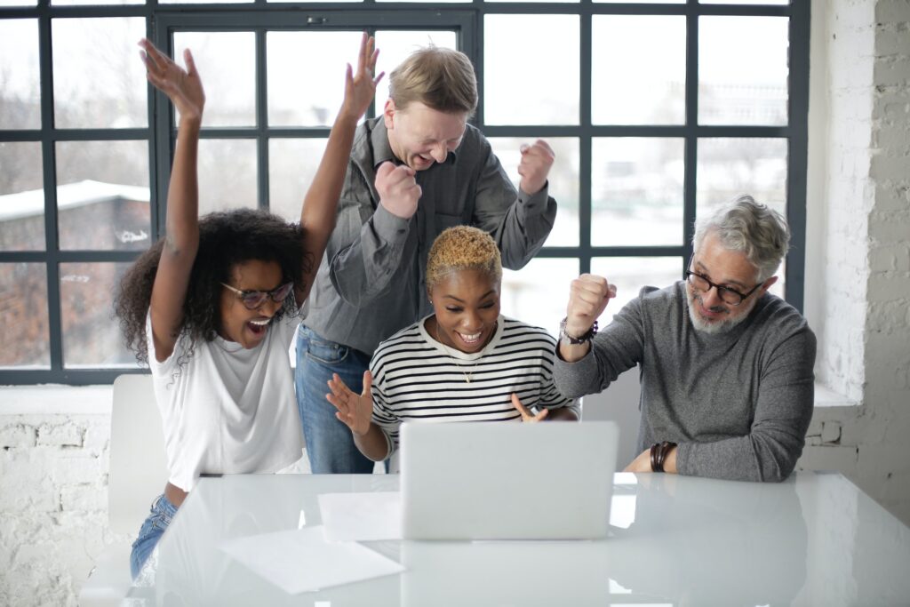 A startup team celebrating their new backlink profie