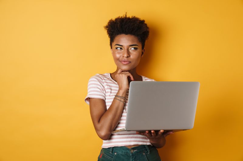 A thoughtful-looking woman holding a laptop considering SEO strategies like citation link building